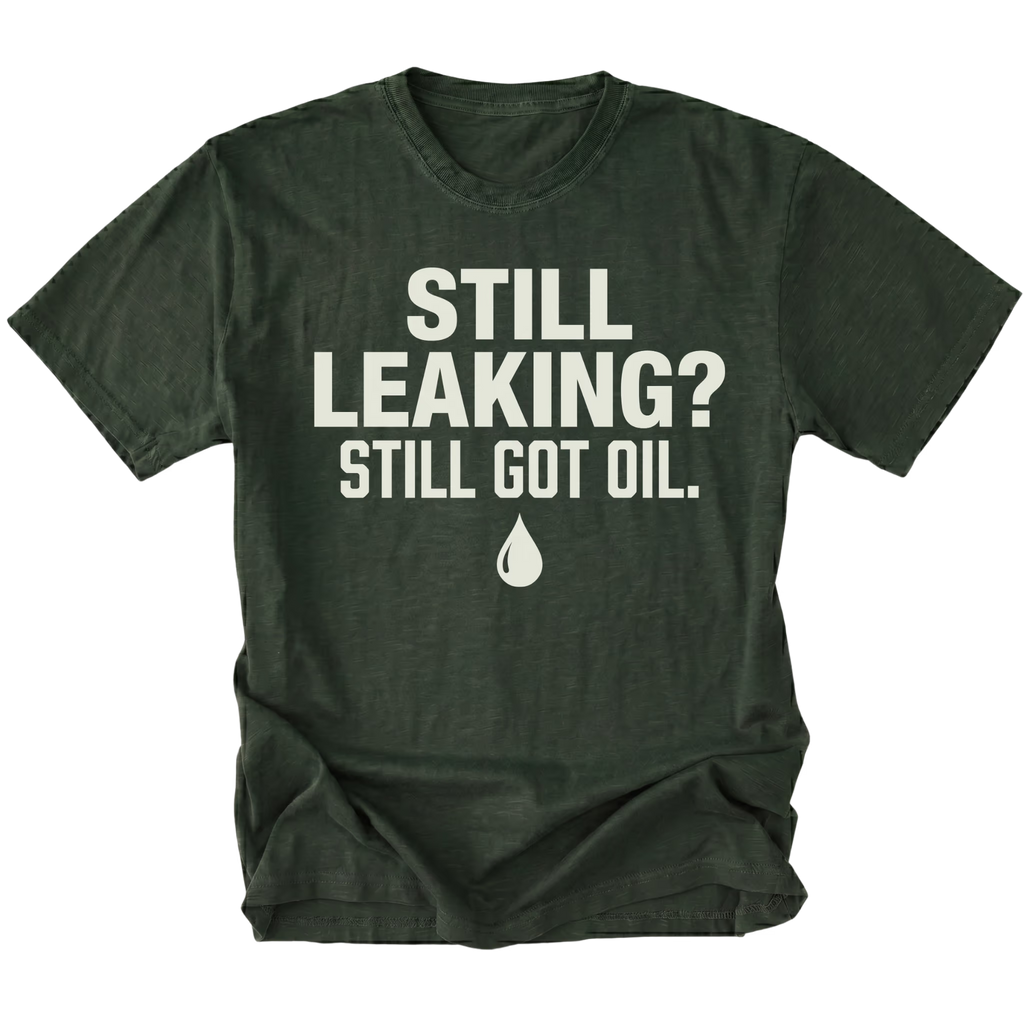 Moss T-Shirt featuring the Still Leaking? Still Got Oil. design with an oil drop graphic on the front view by Trail Snark.