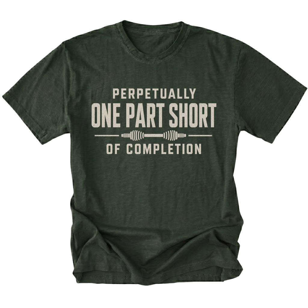 Moss T-shirt with a Perpetually One Part Short Of Completion garage build design shown from the front by Trail Snark.