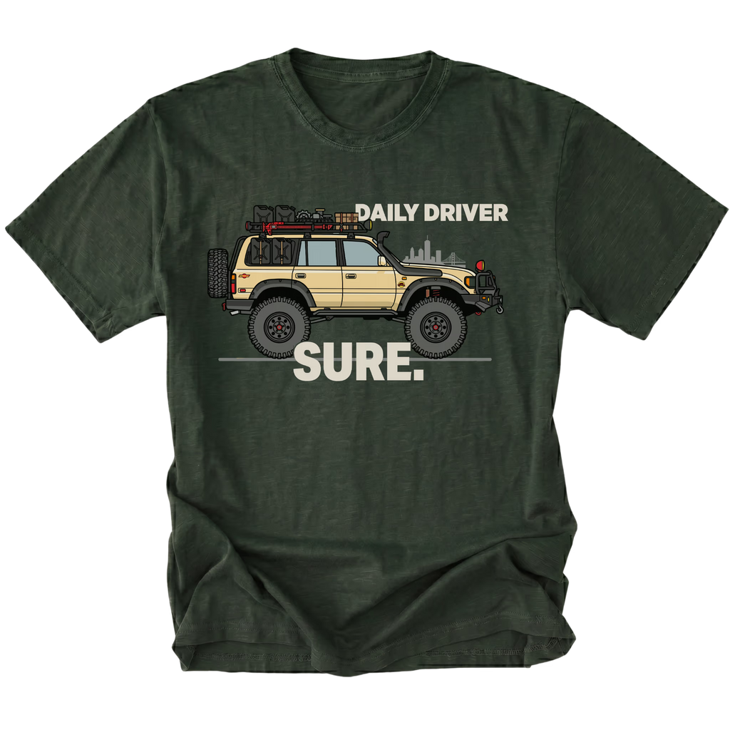 Moss t-shirt featuring a built off-road vehicle with daily driver sure text graphic shown from the front by Trail Snark.