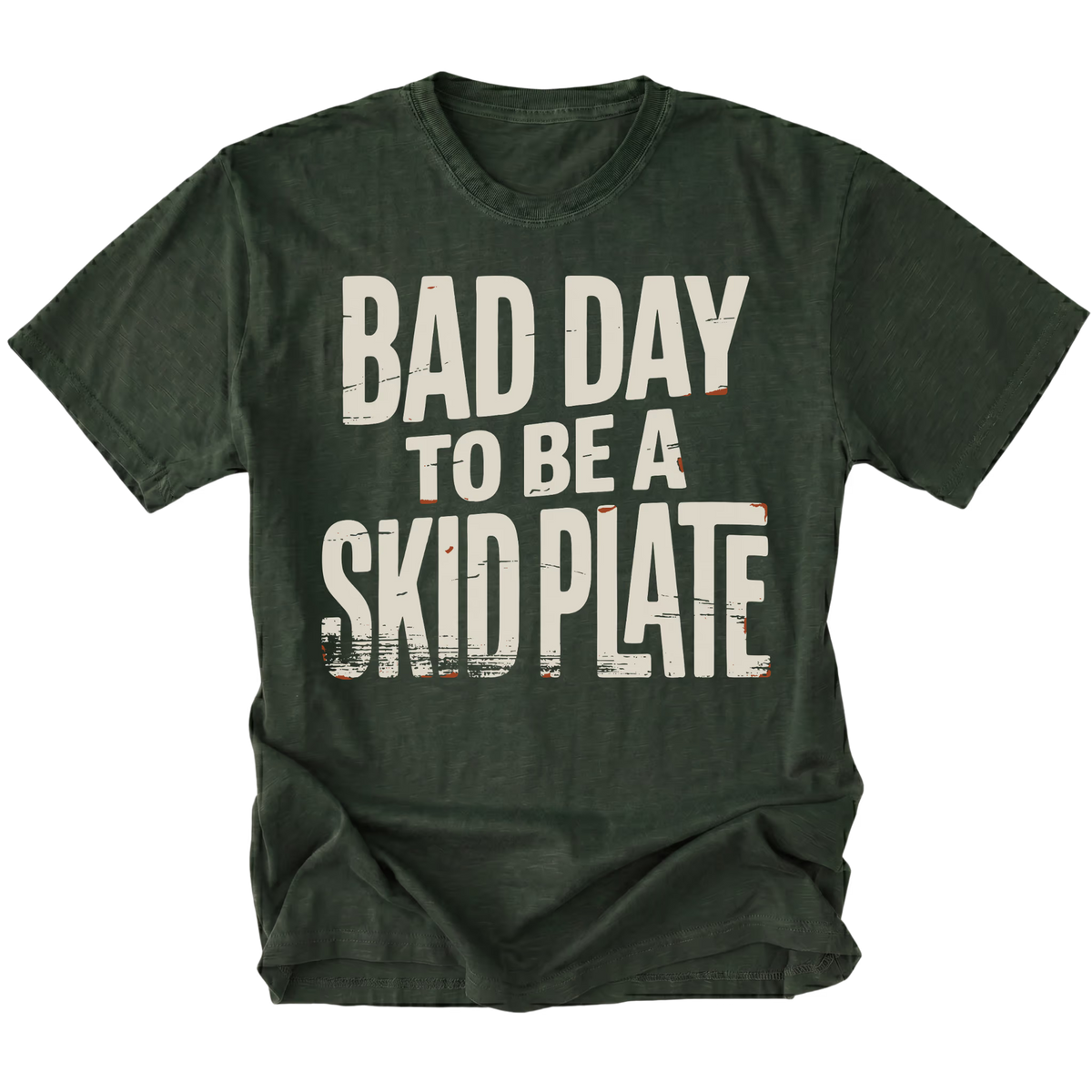 A moss green t-shirt with a distressed white graphic text that reads 'BAD DAY TO BE A SKID PLATE' on the front, displayed against a solid white background.