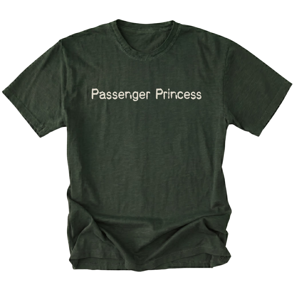 A moss green short-sleeve t-shirt with the words 'Passenger Princess' printed in a light beige serif font across the chest, displayed against a solid white background.