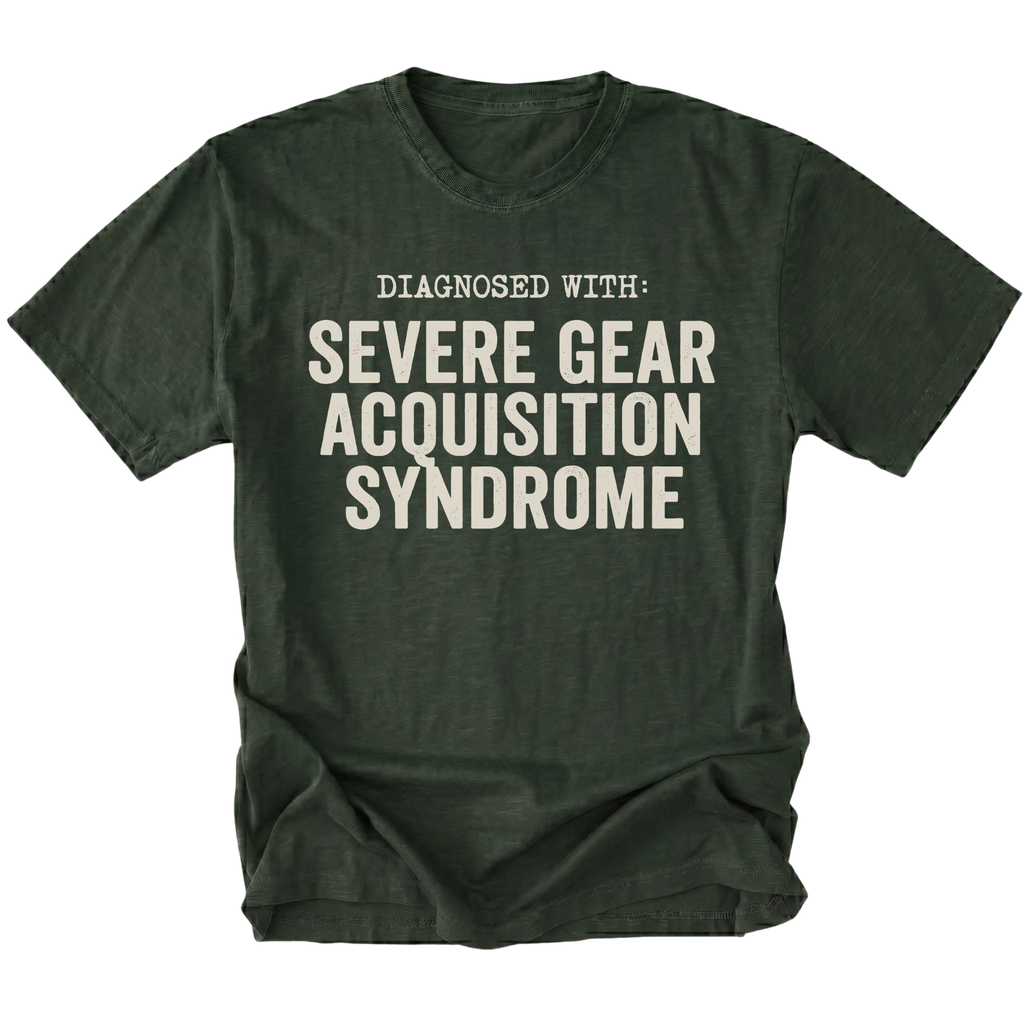 Moss t-shirt featuring diagnosed with severe gear acquisition syndrome bold text graphic shown from the front by Trail Snark.