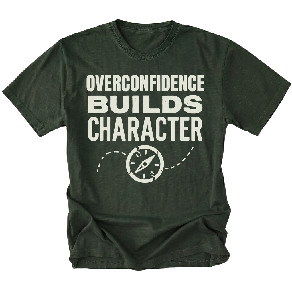 Moss T-Shirt with “Overconfidence Builds Character” text and compass graphic shown on front view by Trail Snark.