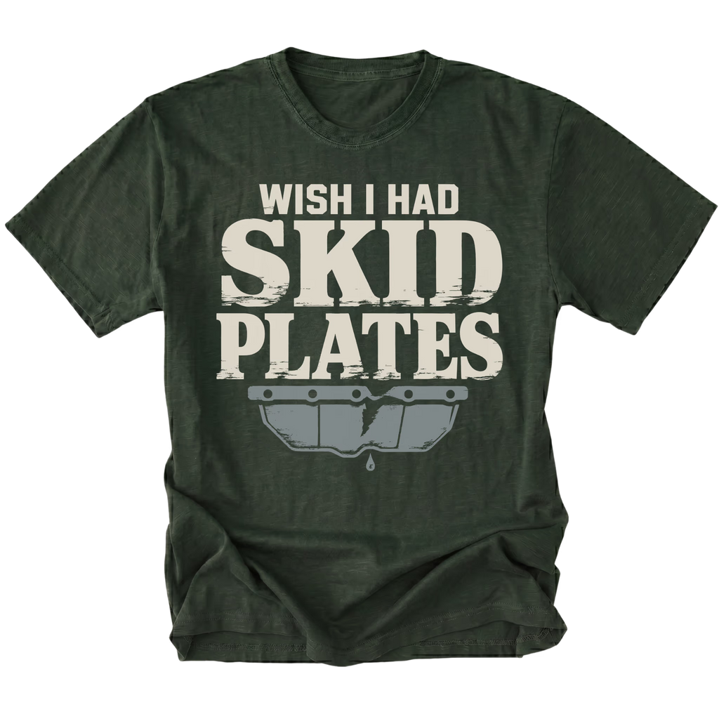A moss forest green t-shirt with a distressed graphic that reads 'WISH I HAD SKID PLATES' in off-white text above a gray car bumper graphic, shown on a plain white background.