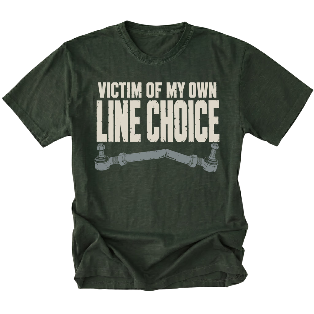 A moss green short-sleeve t-shirt with a distressed white graphic text reading 'VICTIM OF MY OWN LINE CHOICE' above a gray metal control arm illustration, shown on a plain white background.