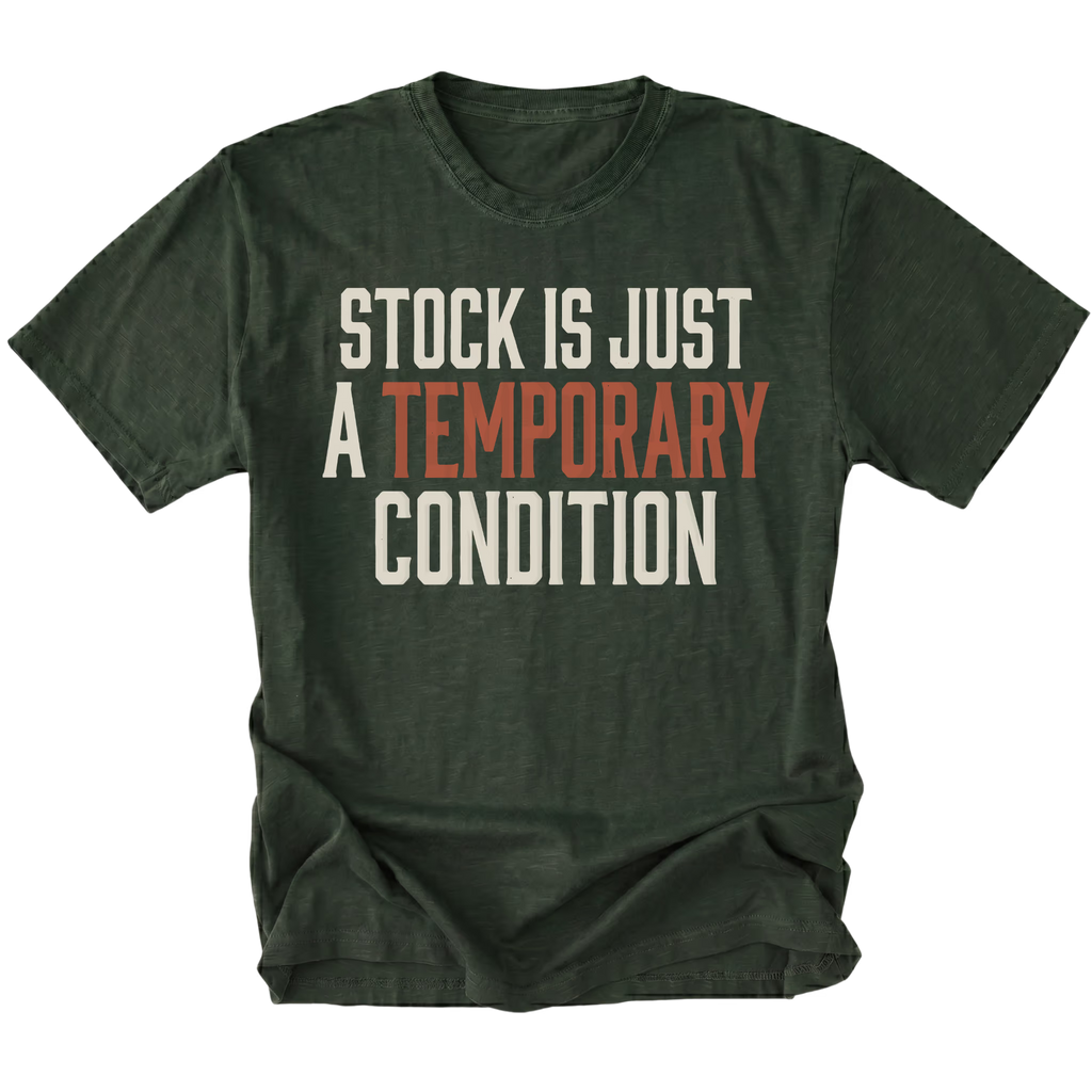 A moss green short-sleeve t-shirt with a distressed graphic text print reading 'STOCK IS JUST A TEMPORARY CONDITION' in cream and muted orange-red lettering, displayed on a solid white background.