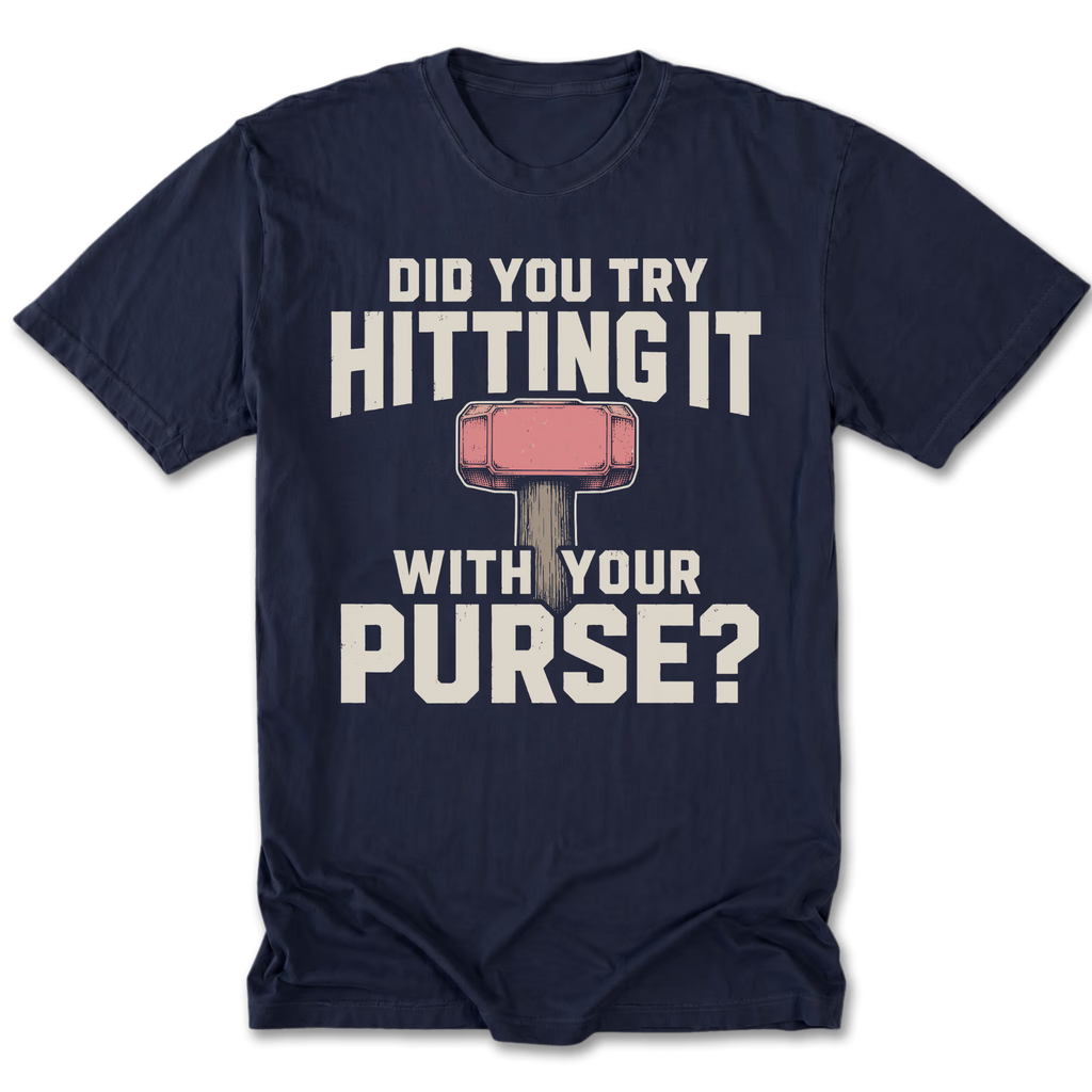 A navy blue short-sleeve t-shirt with a graphic print on the front. The print features the text 'DID YOU TRY HITTING IT WITH YOUR PURSE?' in distressed off-white lettering, with a pink and gray hammer graphic in the center.