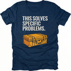 Navy t-shirt with text reading “This Solves Specific Problems” above an illustrated orange hard gear case, shown in front view.