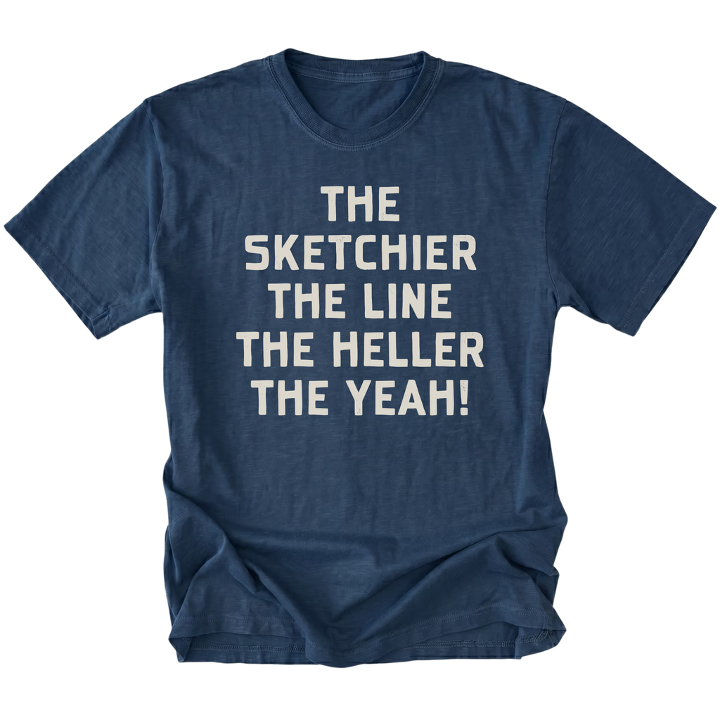 A navy blue short-sleeve t-shirt with a distressed texture, featuring the phrase 'THE SKETCHIER THE LINE THE HELLER THE YEAH!' printed in a bold, light beige sans-serif font across the chest, displayed on a solid white background.