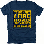Navy t-shirt with yellow warning-style text reading Its Basically A Fire Road Said Moments Before Disaster, front view by Trail Snark.