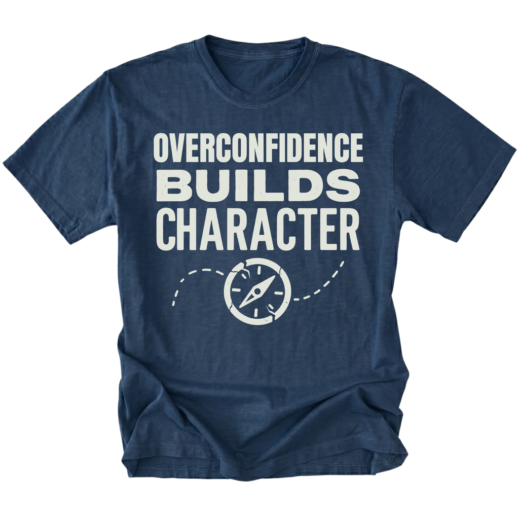 Navy T-Shirt with “Overconfidence Builds Character” text and compass graphic shown on front view by Trail Snark.