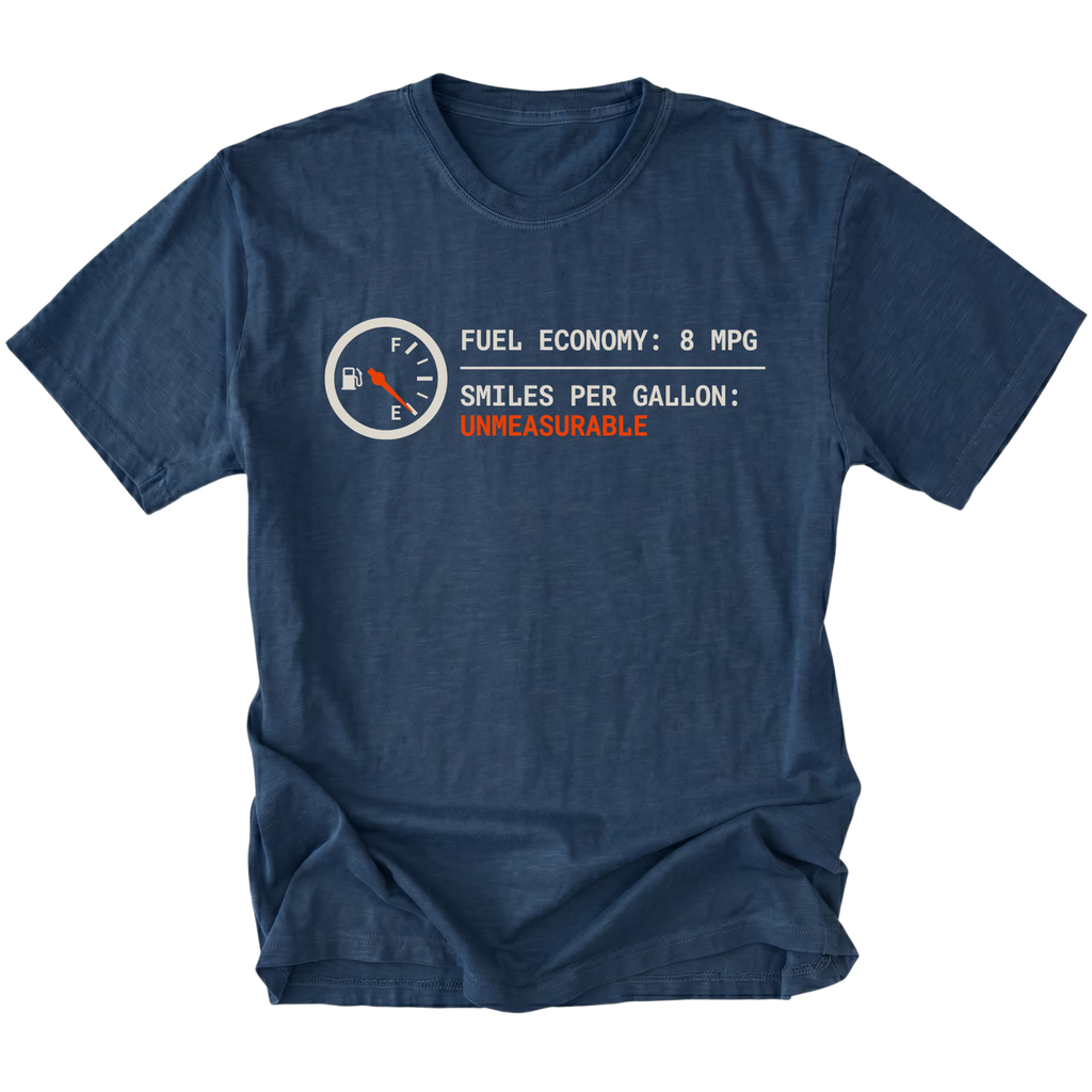 Navy t-shirt featuring a fuel gauge graphic with text reading fuel economy 8 MPG and smiles per gallon unmeasurable displayed on the front.