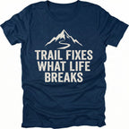 Navy t-shirt with the phrase “Trail Fixes What Life Breaks” beneath a mountain and winding trail graphic printed on the front.