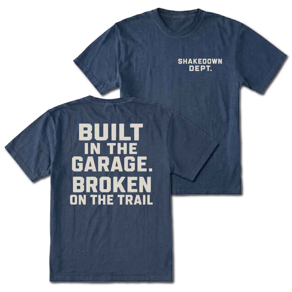 Navy T-shirt with Shakedown Dept front print and Built in the Garage Broken on the Trail back design shown front and back by Trail Snark.