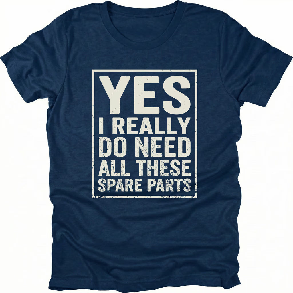 Navy t-shirt with bold distressed text reading “Yes I Really Do Need All These Spare Parts” in a boxed layout on the front by Trail Snark.