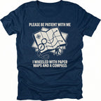 Navy T-Shirt with paper map and compass graphic reading “Please Be Patient With Me I Wheeled With Paper Maps And A Compass” shown on front view by Trail Snark.