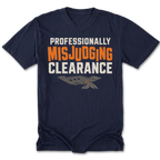 A navy blue short-sleeve t-shirt with a graphic print on the front reading 'PROFESSIONALLY MISJUDGING CLEARANCE' in white and orange lettering, with a gray and orange parachute graphic below, shown on a plain white background.