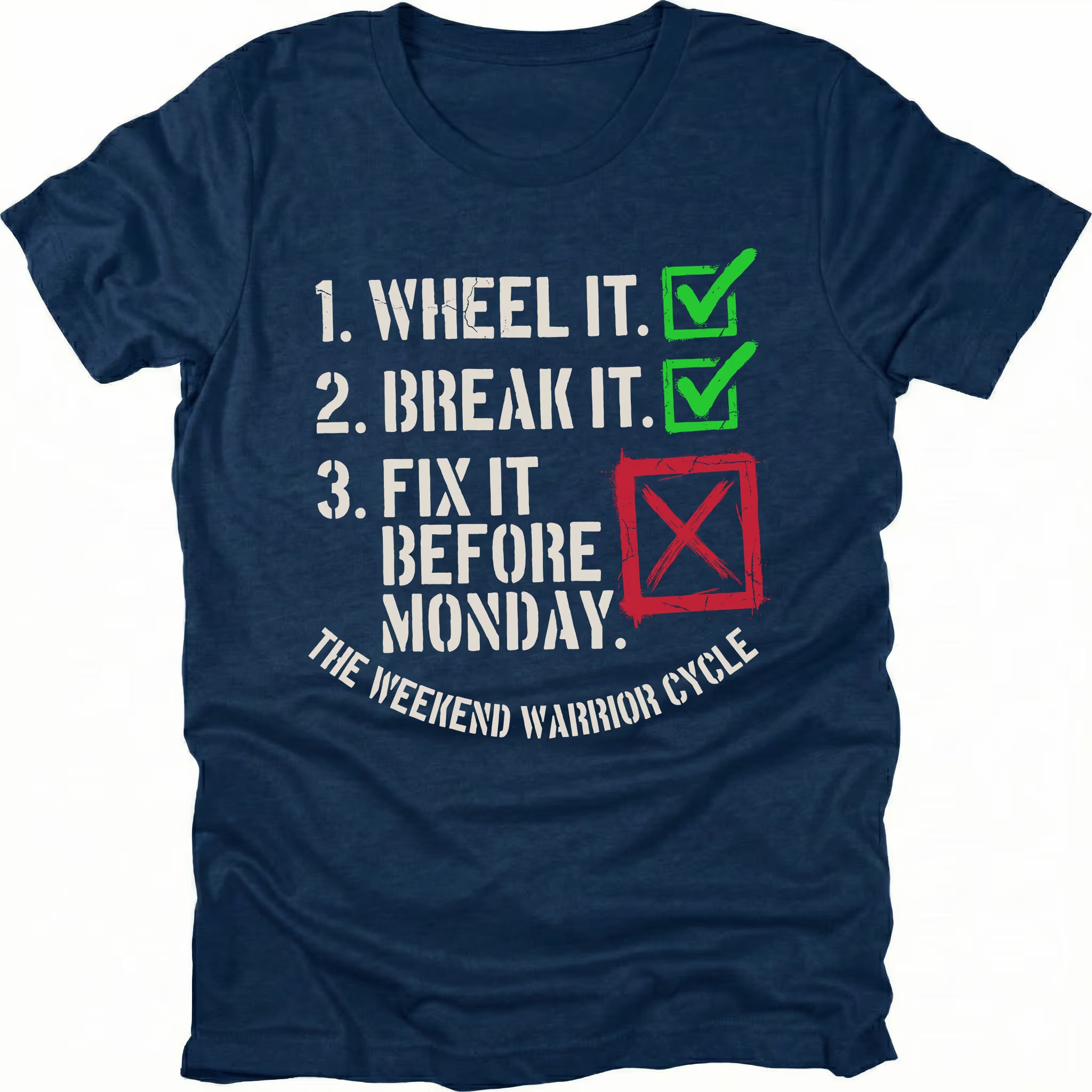 Navy t-shirt with checklist text reading “1. Wheel It. 2. Break It. 3. Fix It Before Monday” with checkmarks and a red X, labeled “The Weekend Warrior Cycle.”