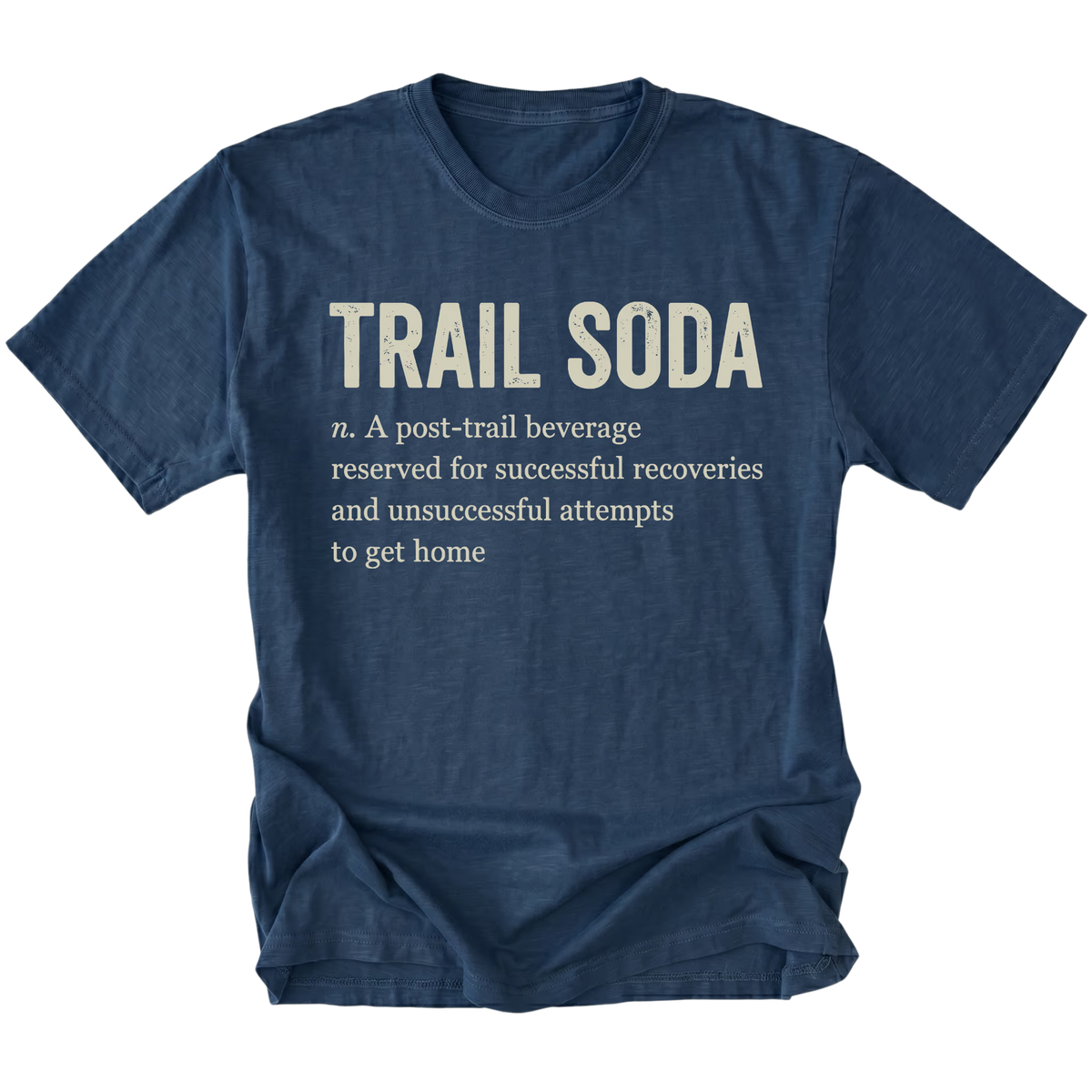 A navy blue short-sleeve t-shirt with a humorous dictionary-style definition printed on the front chest reading 'TRAIL SODA' and a smaller definition below, shown on a plain white background.