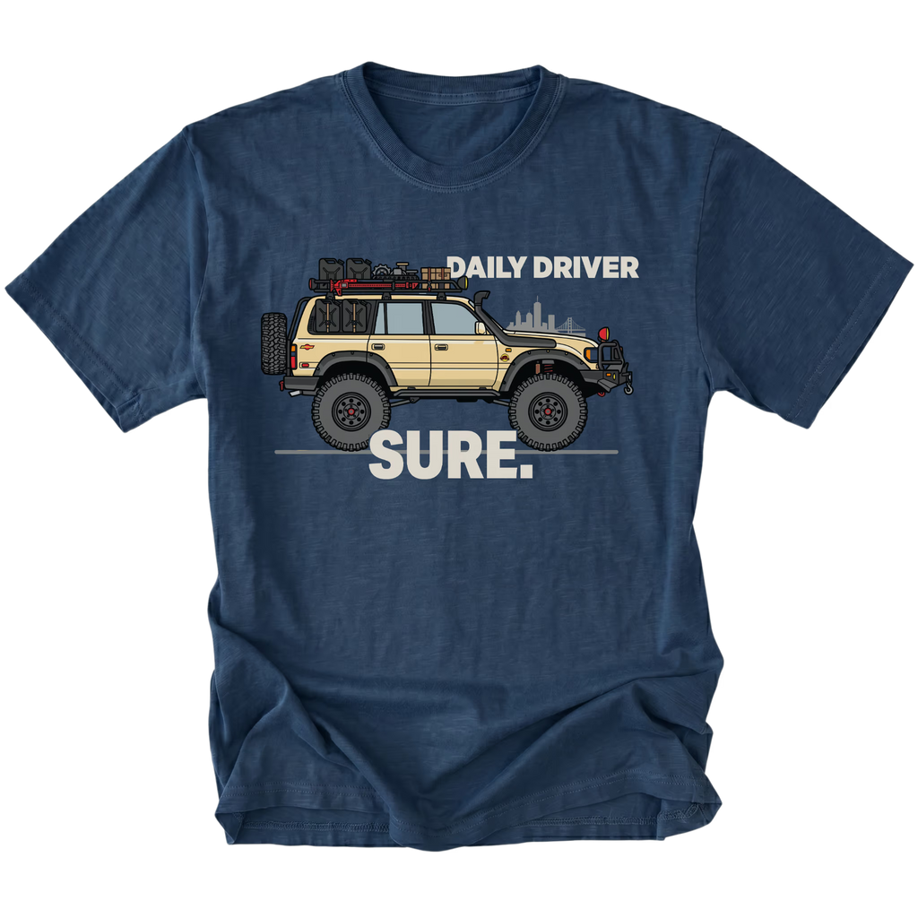 Navy t-shirt featuring a built off-road vehicle with daily driver sure text graphic shown from the front by Trail Snark.