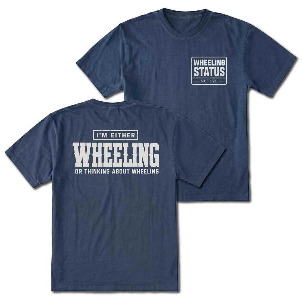 Navy T-shirt with I'm Either Wheeling Or Thinking About Wheeling back design and Wheeling Status front chest print by Trail Snark.
