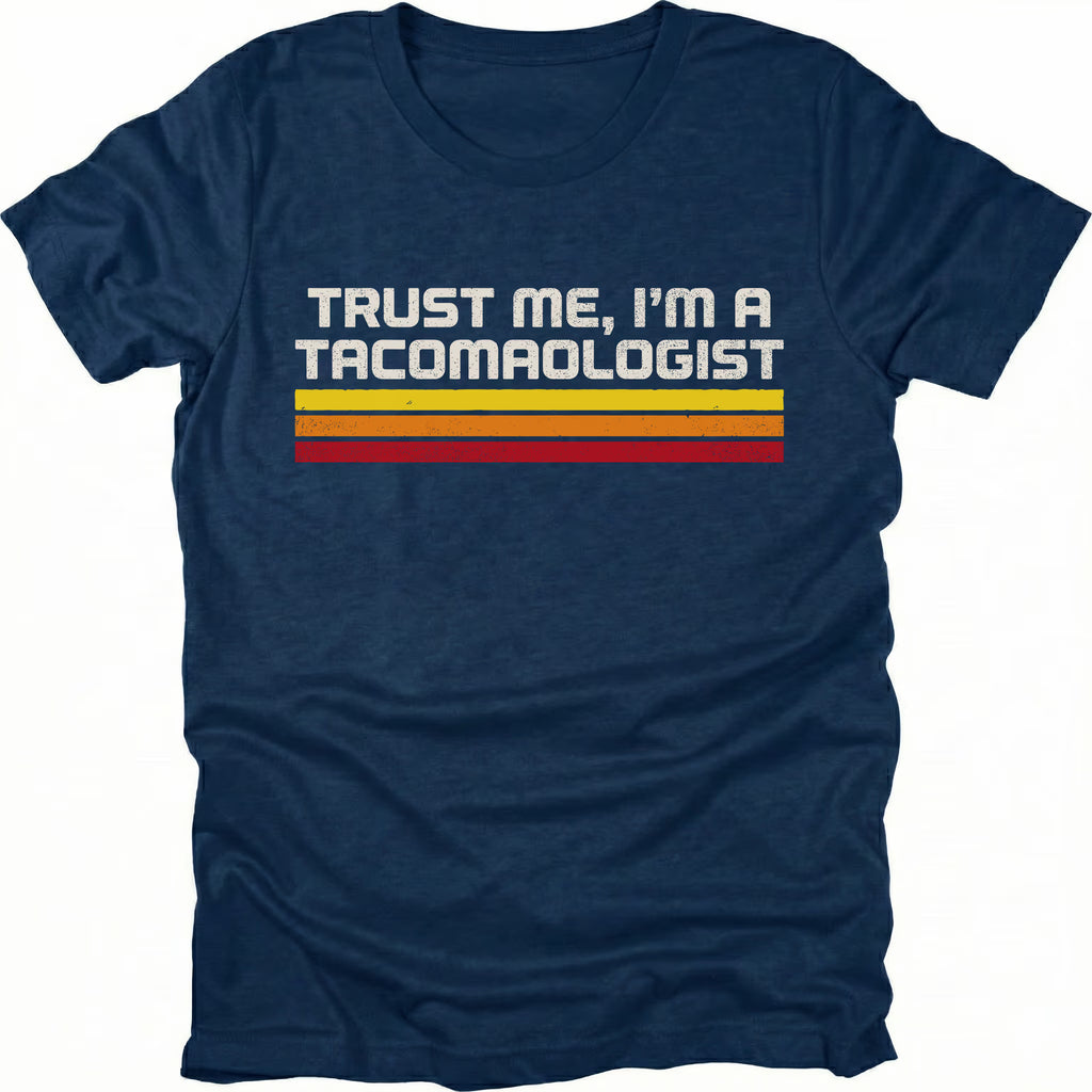 Navy t-shirt with retro stripes and the phrase “Trust Me, I’m a Tacomaologist” printed on the front by Trail Snark.