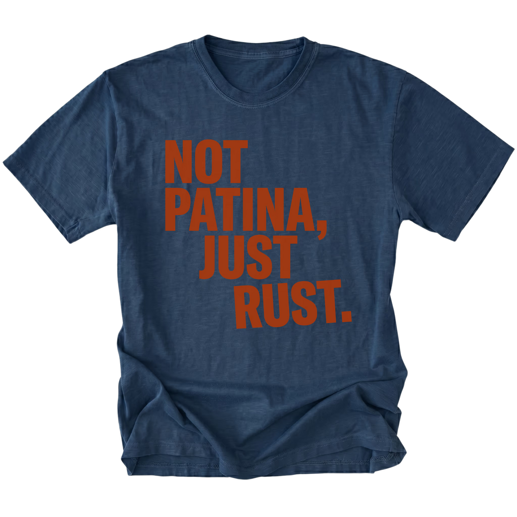 Navy t-shirt with bold rust-colored text reading Not Patina, Just Rust on the front.