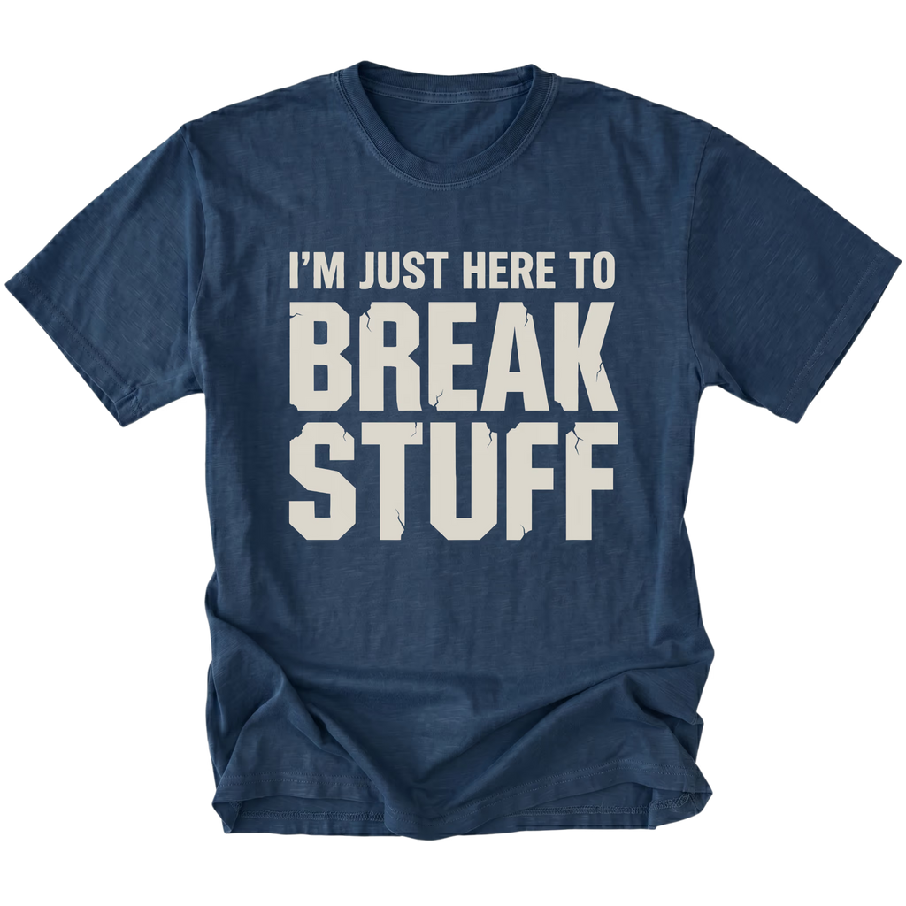 Navy t-shirt with bold distressed text reading I’m Just Here To Break Stuff, front view by Trail Snark.
