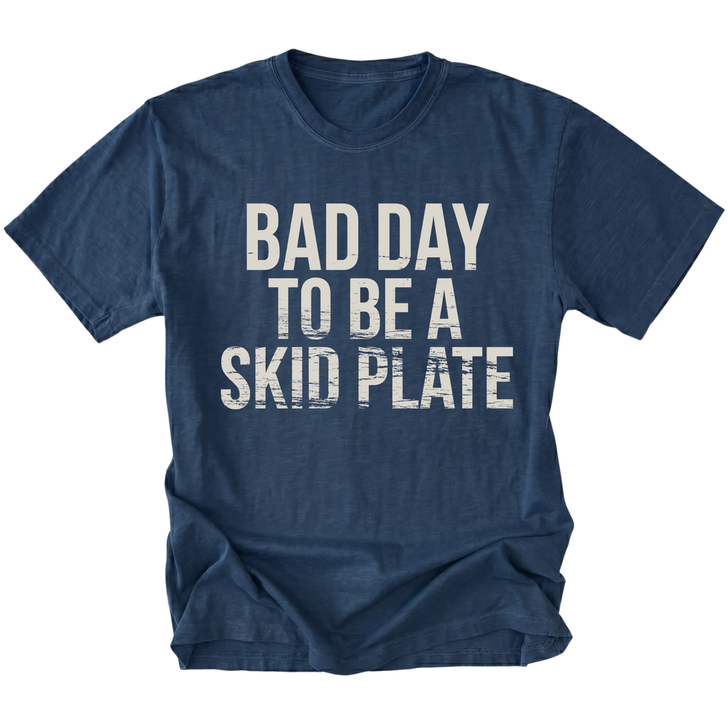 Navy t-shirt featuring bold bad day to be a skid plate text graphic shown from the front by Trail Snark.