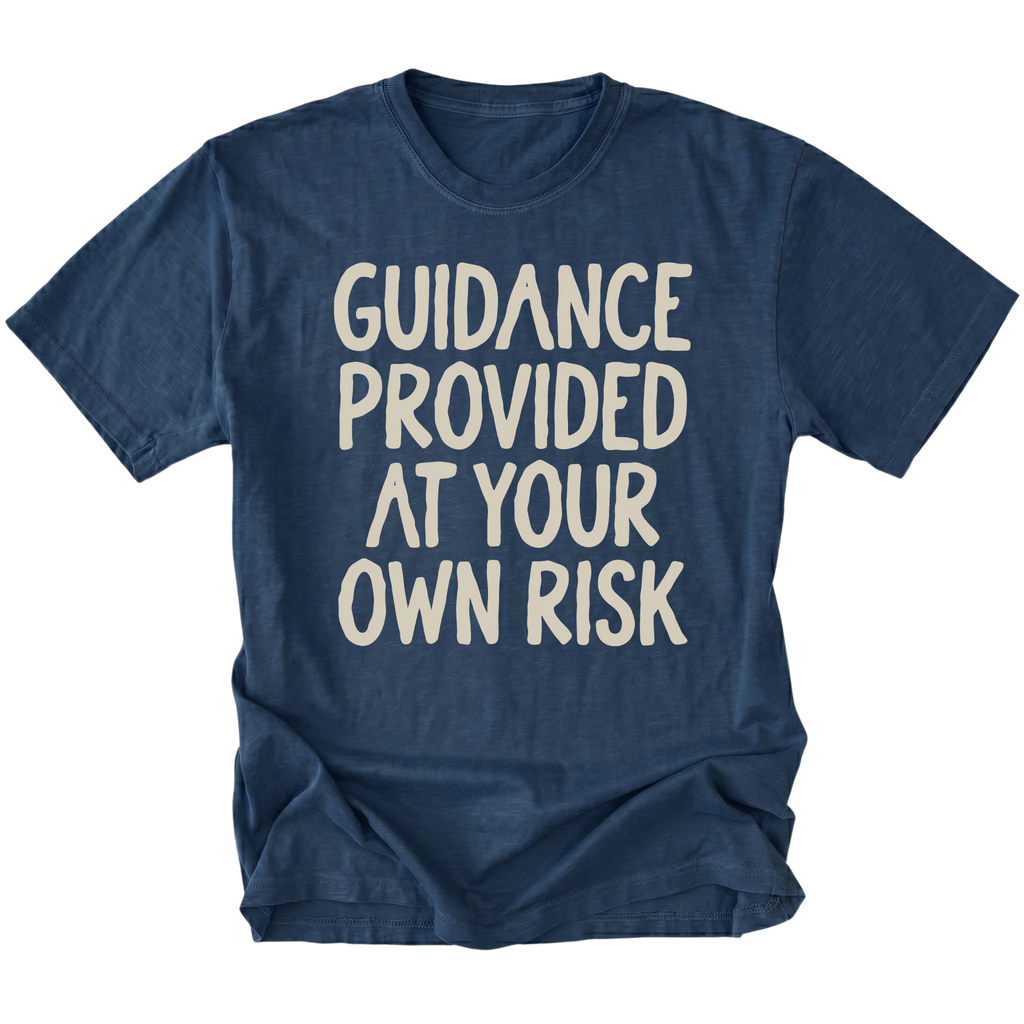 A navy blue t-shirt featuring the text 'GUIDANCE PROVIDED AT YOUR OWN RISK'.