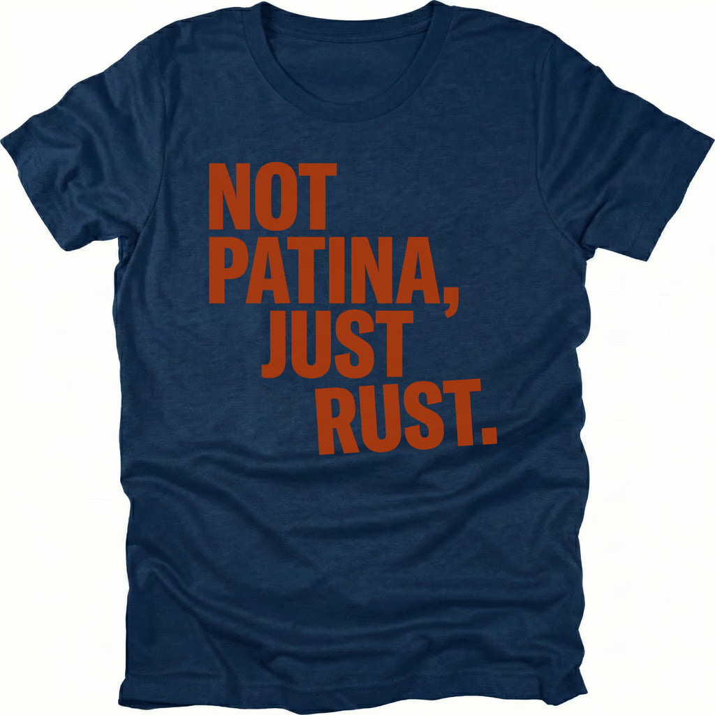 Navy t-shirt with bold rust-colored text reading Not Patina, Just Rust on the front.