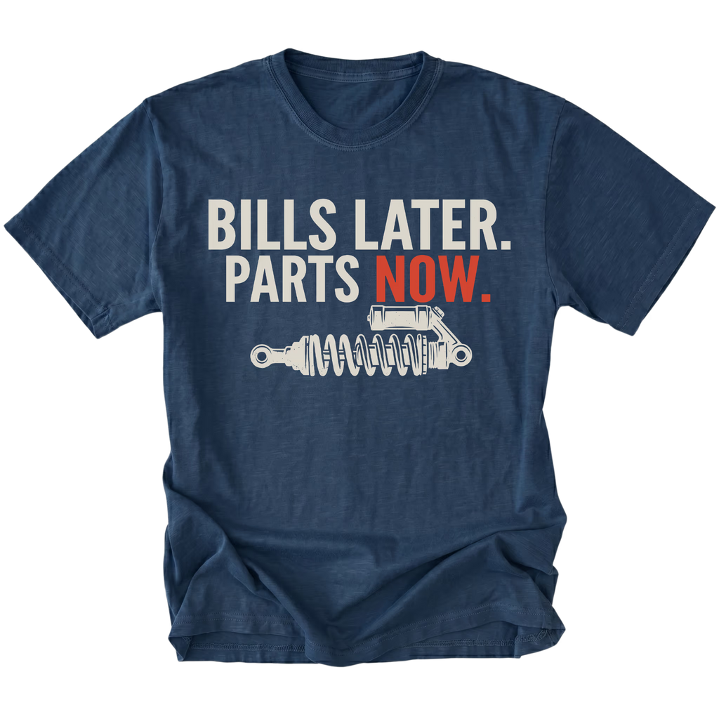 Navy t-shirt featuring Bills Later Parts Now design with suspension coilover graphic on front view by Trail Snark.